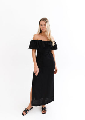 Woman wearing a black off-shoulder dress on a white background